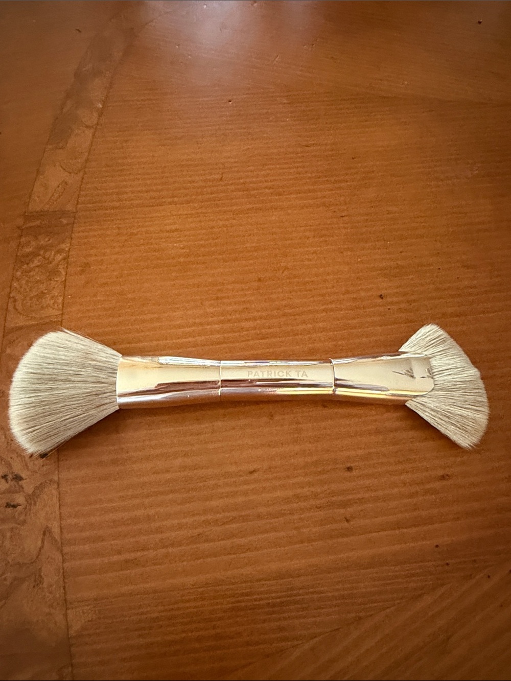 Patrick Ta Rose Gold Double-Ended Fan Brush applies cream and powder.